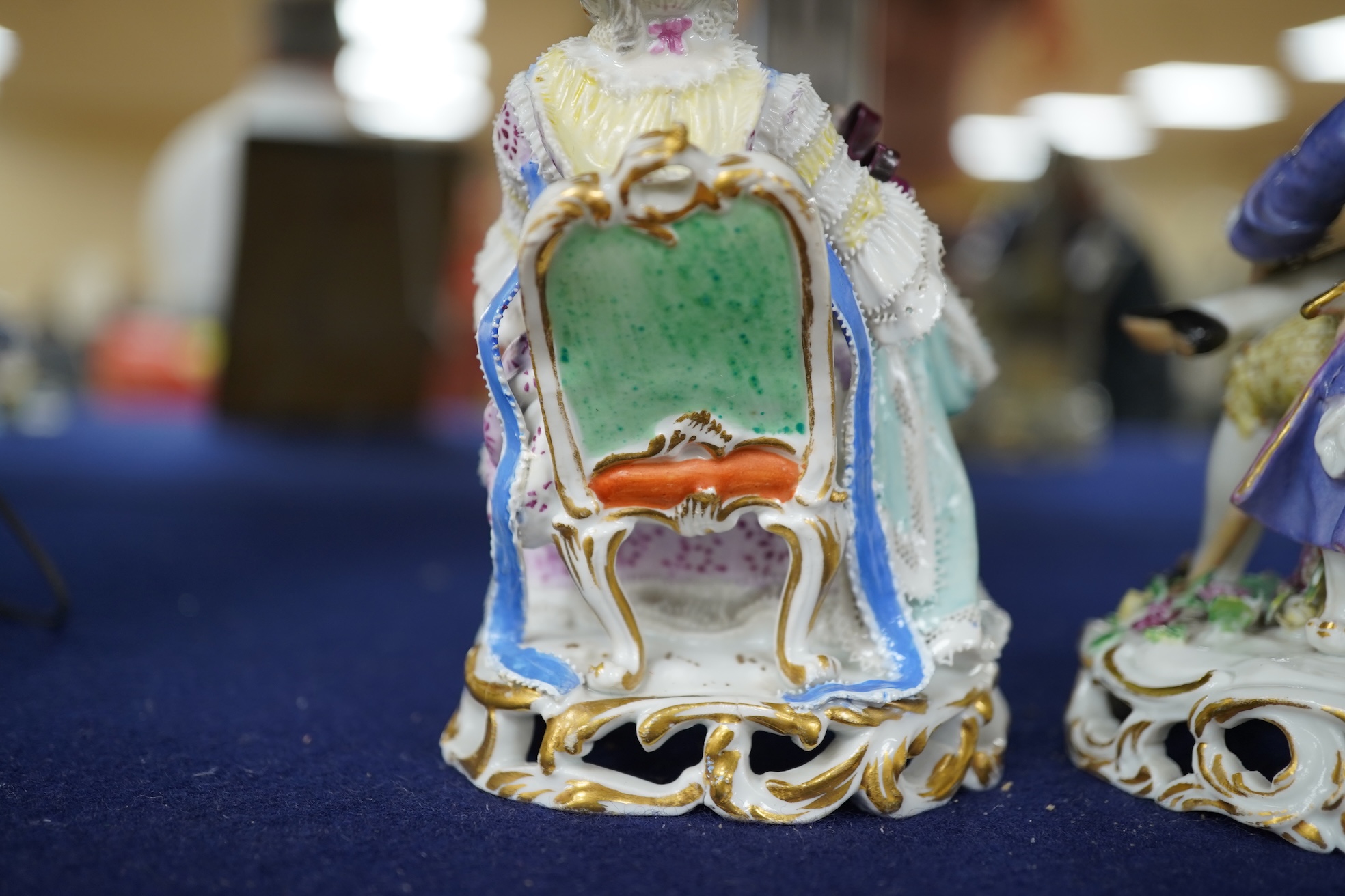 A pair of 19th century Meissen figures of a girl holding a shell and a boy holding a book, in size model number 628, tallest 13cm